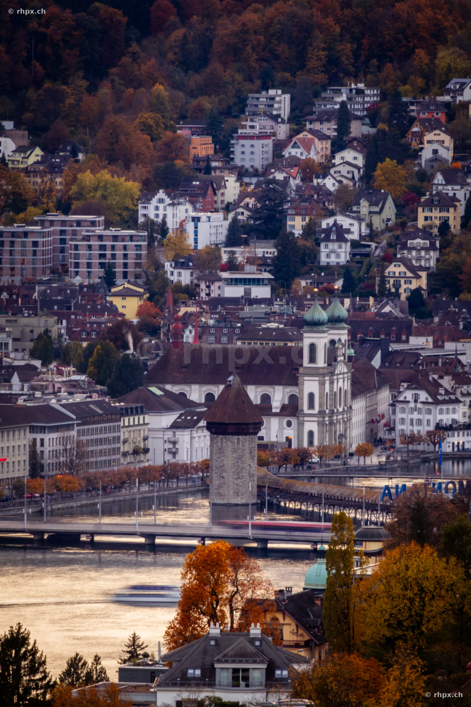 View over the city of Lucerne with Hofkirche and Chapel Bridge in autumn