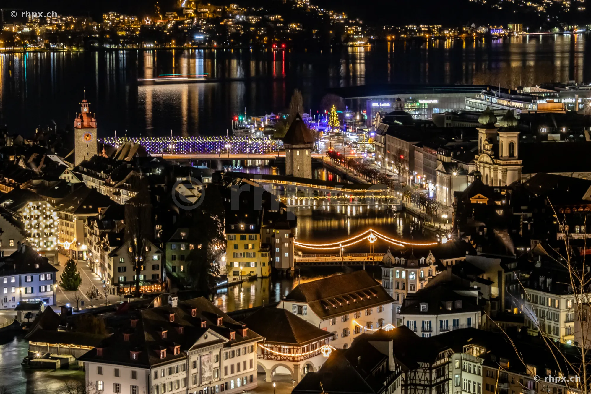 Night view from above of the Christmas-lit old town of Lucerne with Chapel Bridge and Reuss river