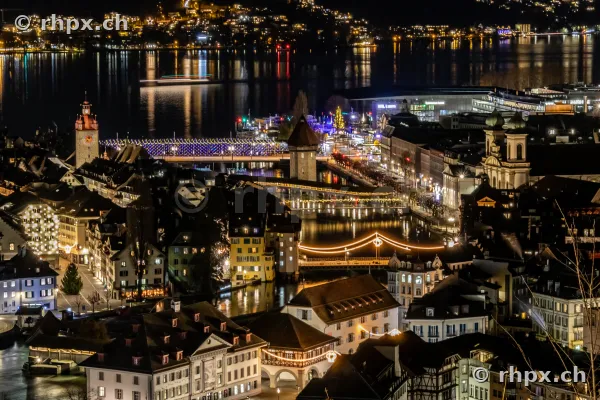 Night view from above of the Christmas-lit old town of Lucerne with Chapel Bridge and Reuss river