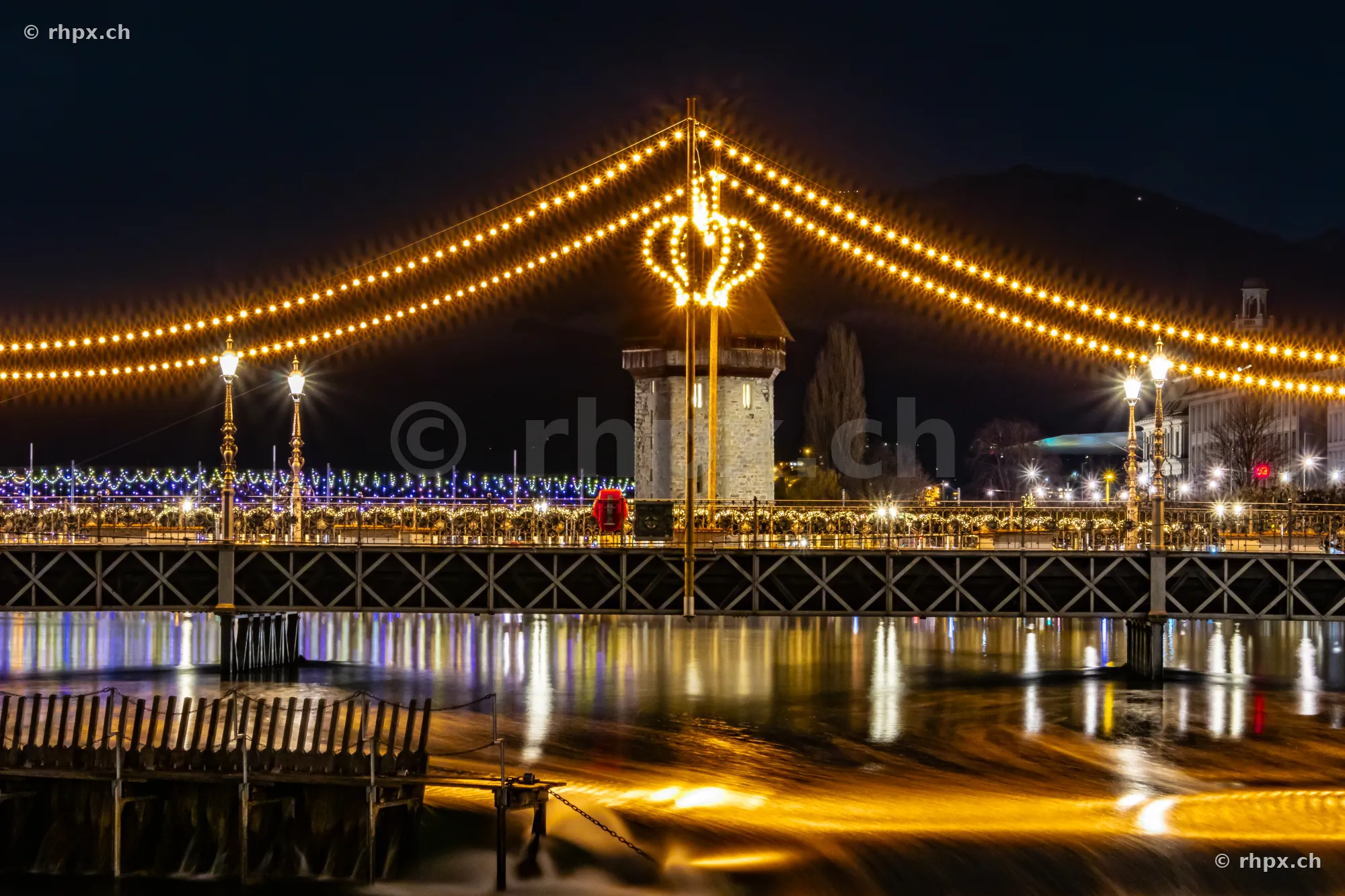 Christmas lighting of the Chapel Bridge and Wasserturm in Lucerne at night
