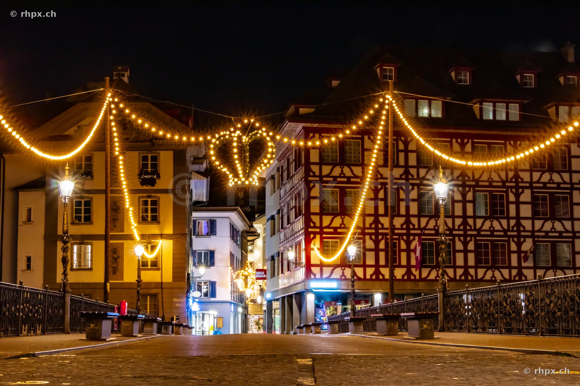 Christmas fairy lights in a night alley of Lucerne old town