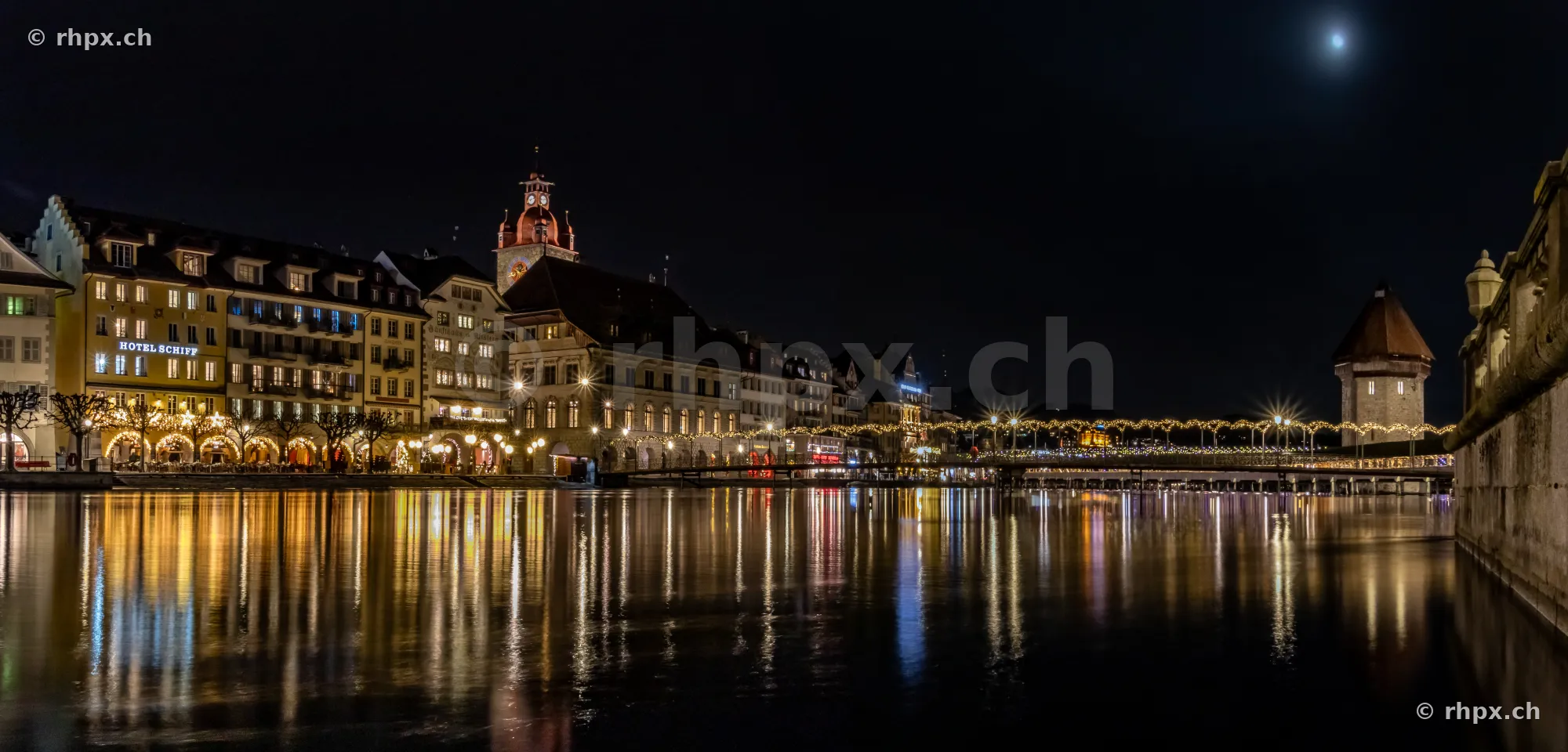 Night view of the Lucerne riverfront with festive Christmas lights along the Reuss