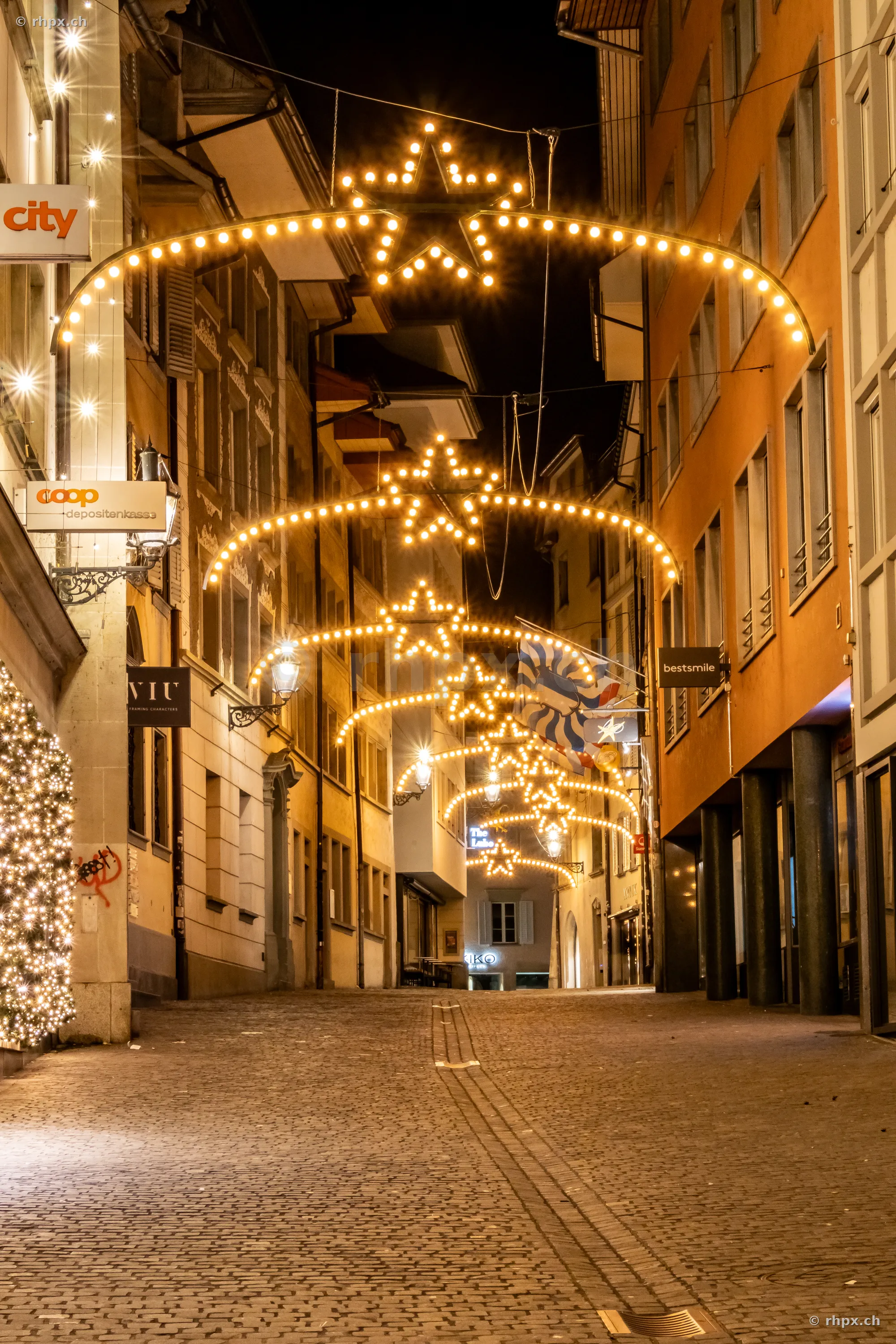 Night alley in Lucerne with illuminated star fairy lights