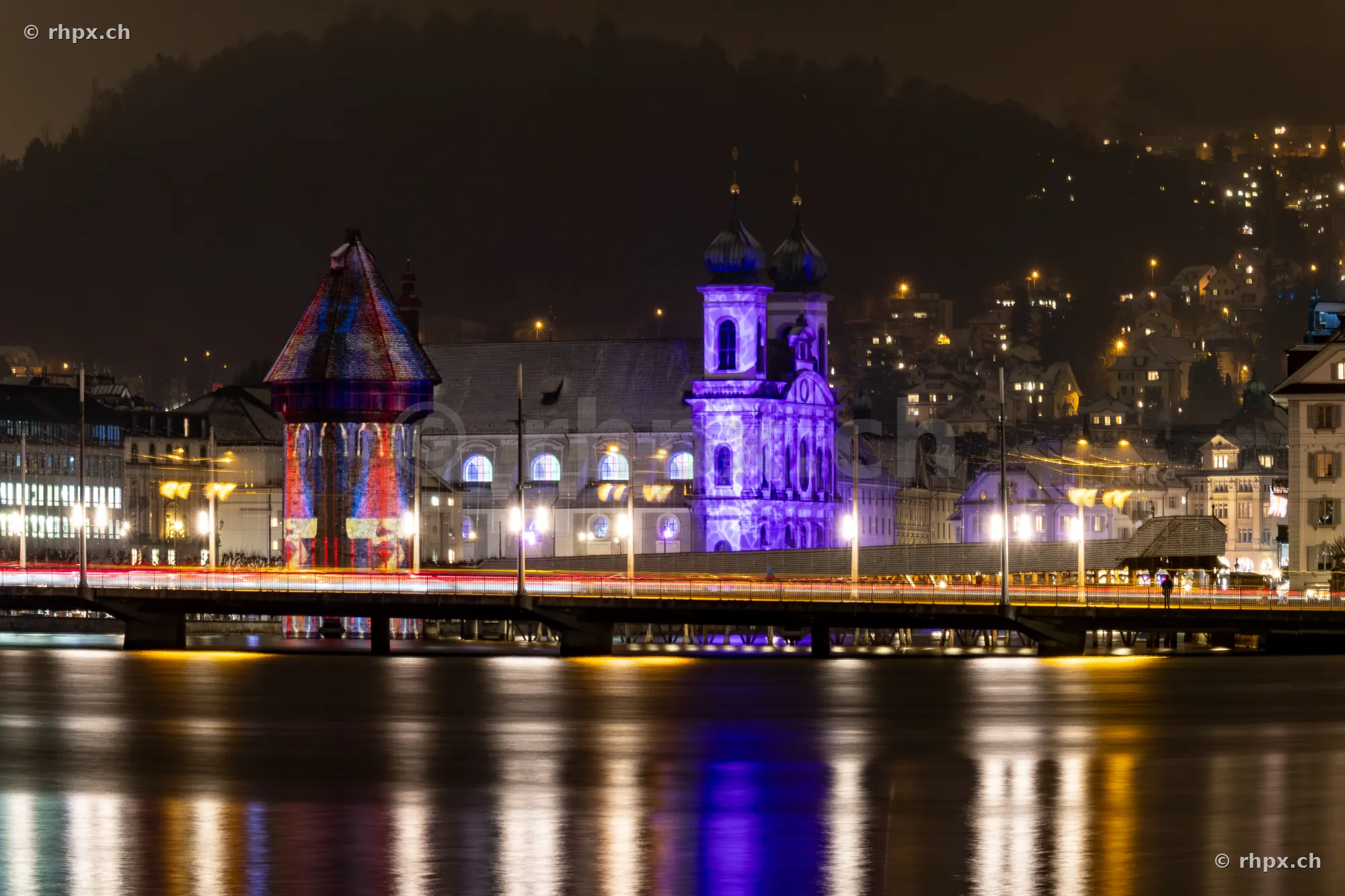 Illuminated facade of the Jesuit Church during the Lilu Light Festival in Lucerne at night