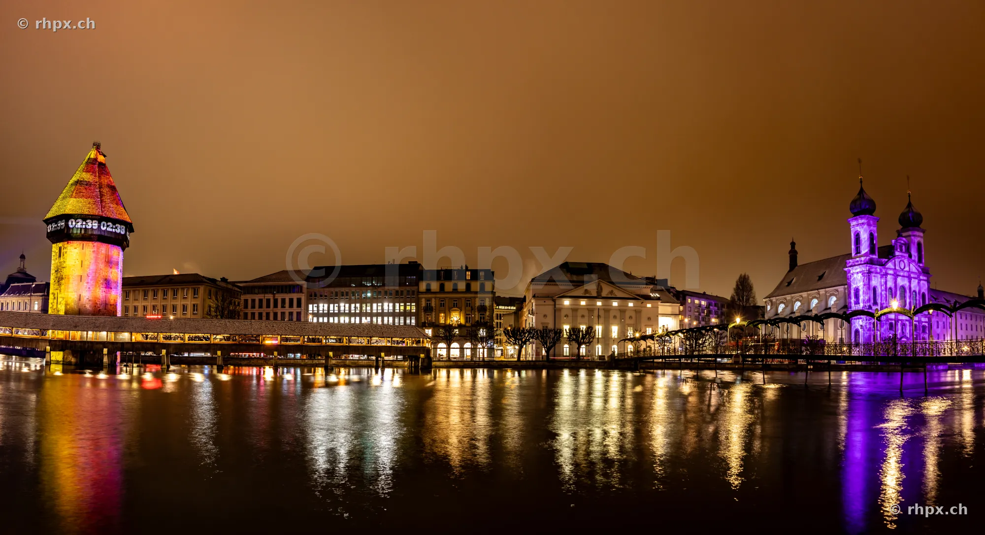 Light installations at the Chapel Bridge and Jesuit Church during the Lilu Light Festival in Lucerne.