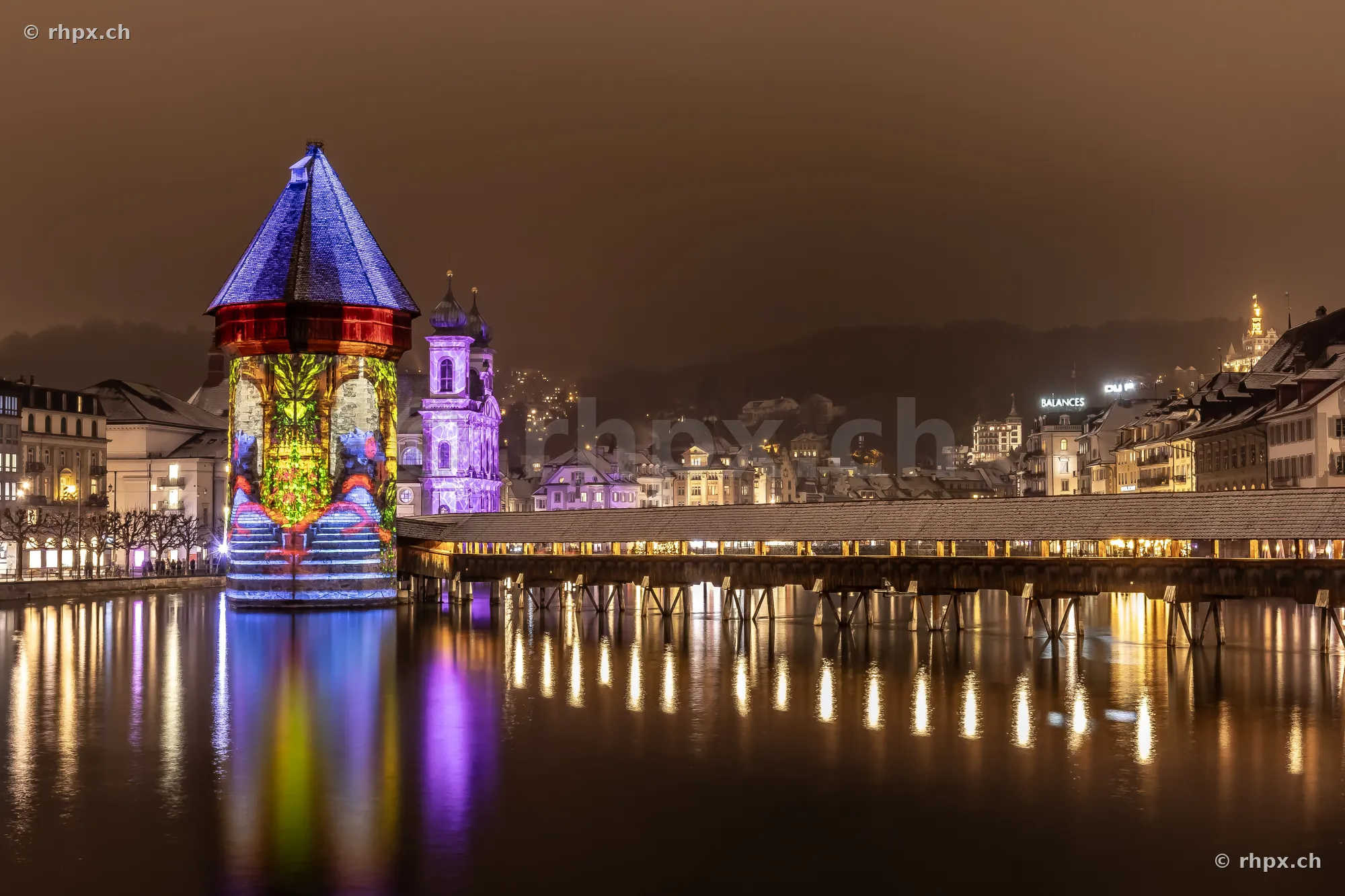 Wasserturm and Chapel Bridge illuminated during the Lilu Light Festival in Lucerne at night