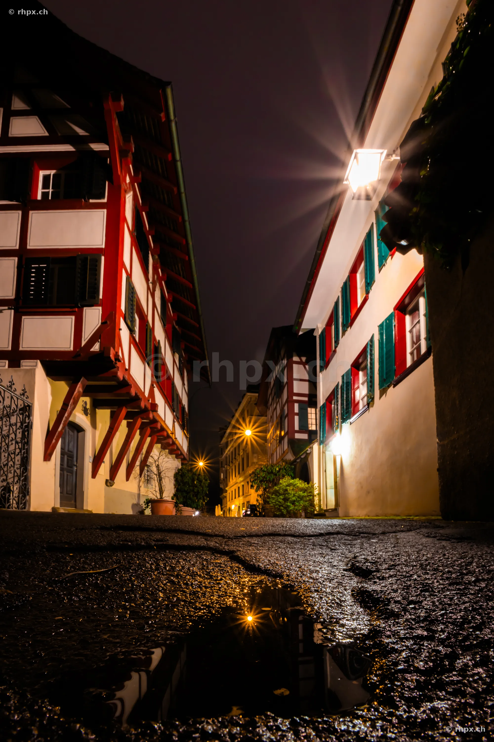 Low-angle view of a night alley with half-timbered houses in the old town of Lucerne