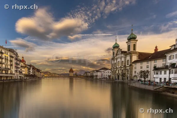 Jesuit Church and Chapel Bridge on the Reuss river in Lucerne at dusk
