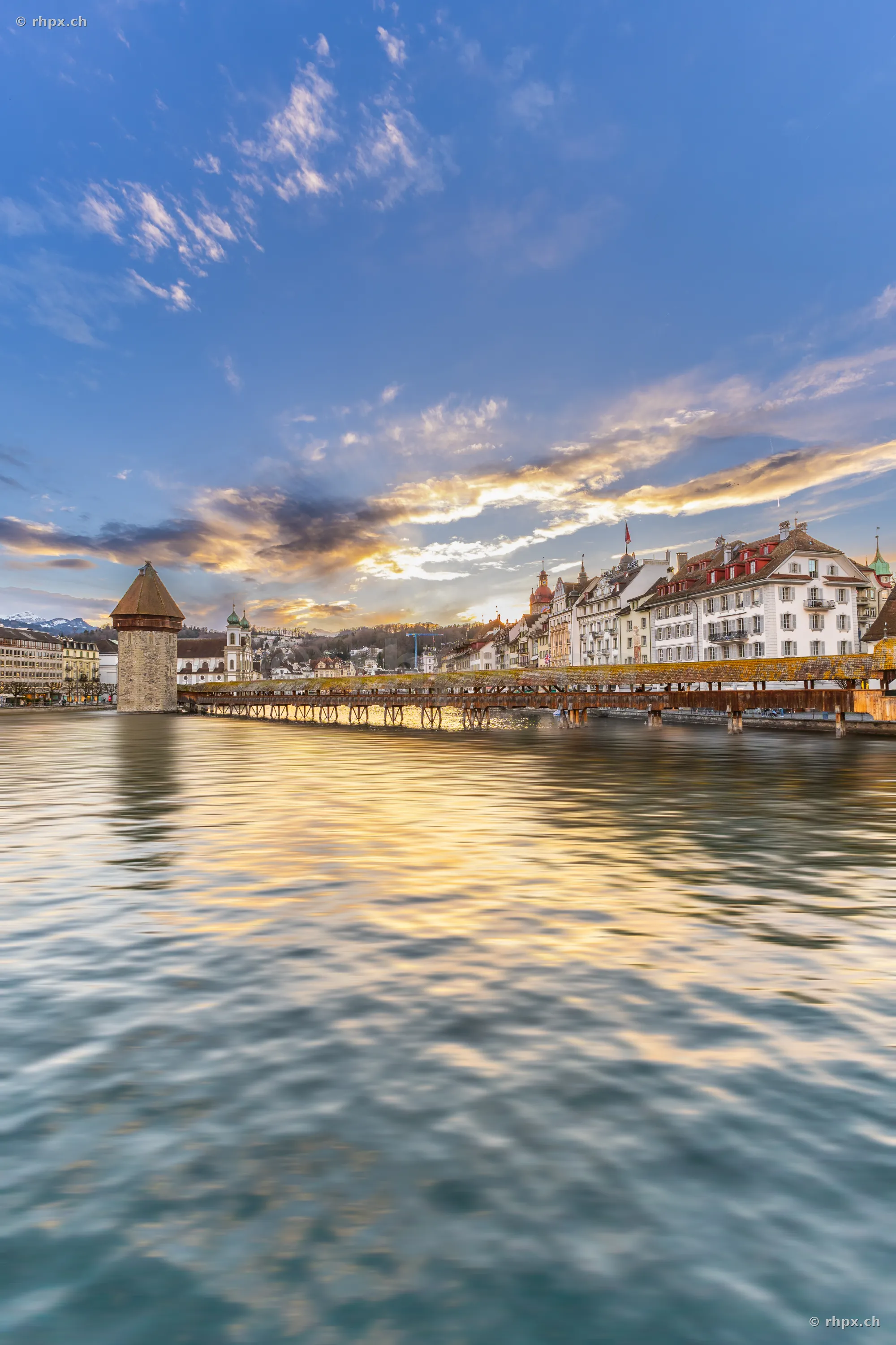 View of the Chapel Bridge and Water Tower in Lucerne at sunset