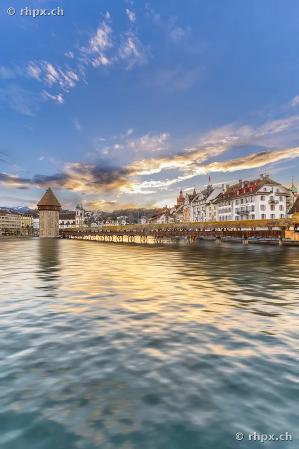 View of the Chapel Bridge and Water Tower in Lucerne at sunset