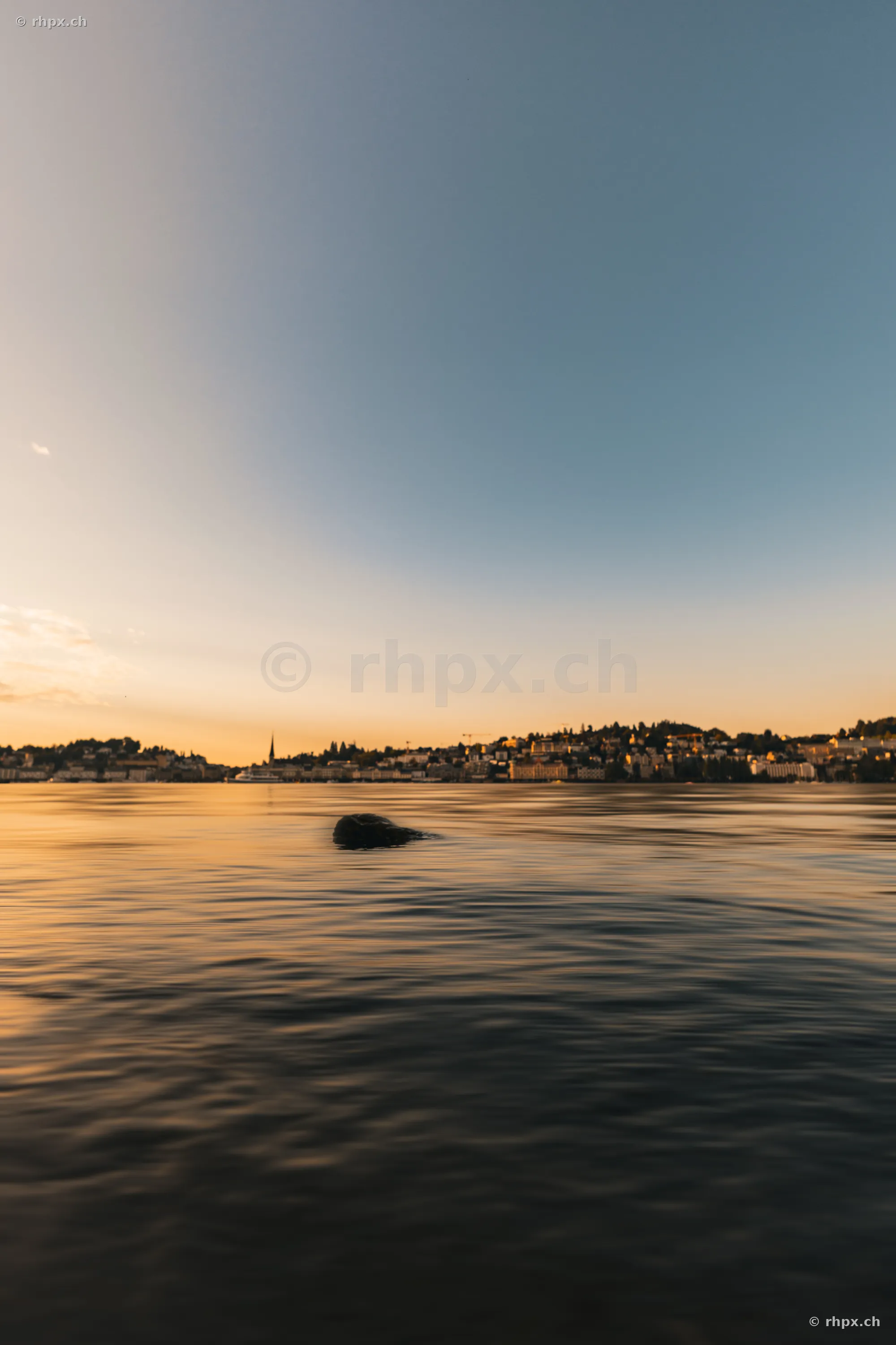 View of Lake Lucerne and the city of Lucerne in the golden light of dusk
