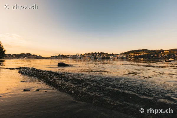 View from the lakeshore towards Lake Lucerne and the city of Lucerne at sunset