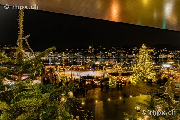 Christmas market with ice rink and Christmas tree at the Lucerne lakeside at night