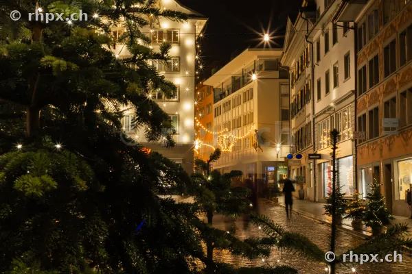Christmas-decorated street in the old town of Lucerne at night with string lights