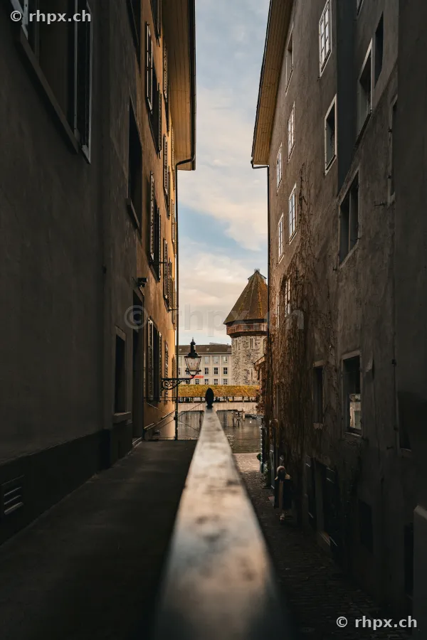 View through a narrow alley in Lucerne towards the water tower