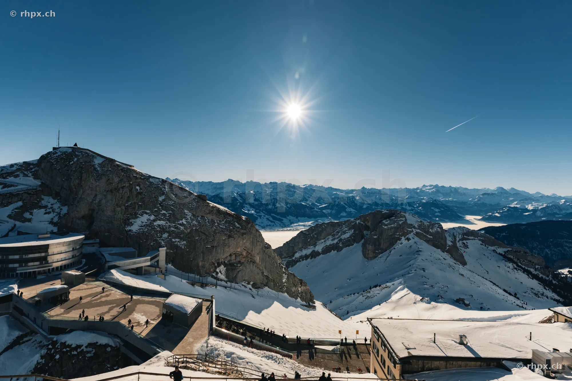 View from Pilatus Kulm over the snow-covered mountain landscape in sunny weather