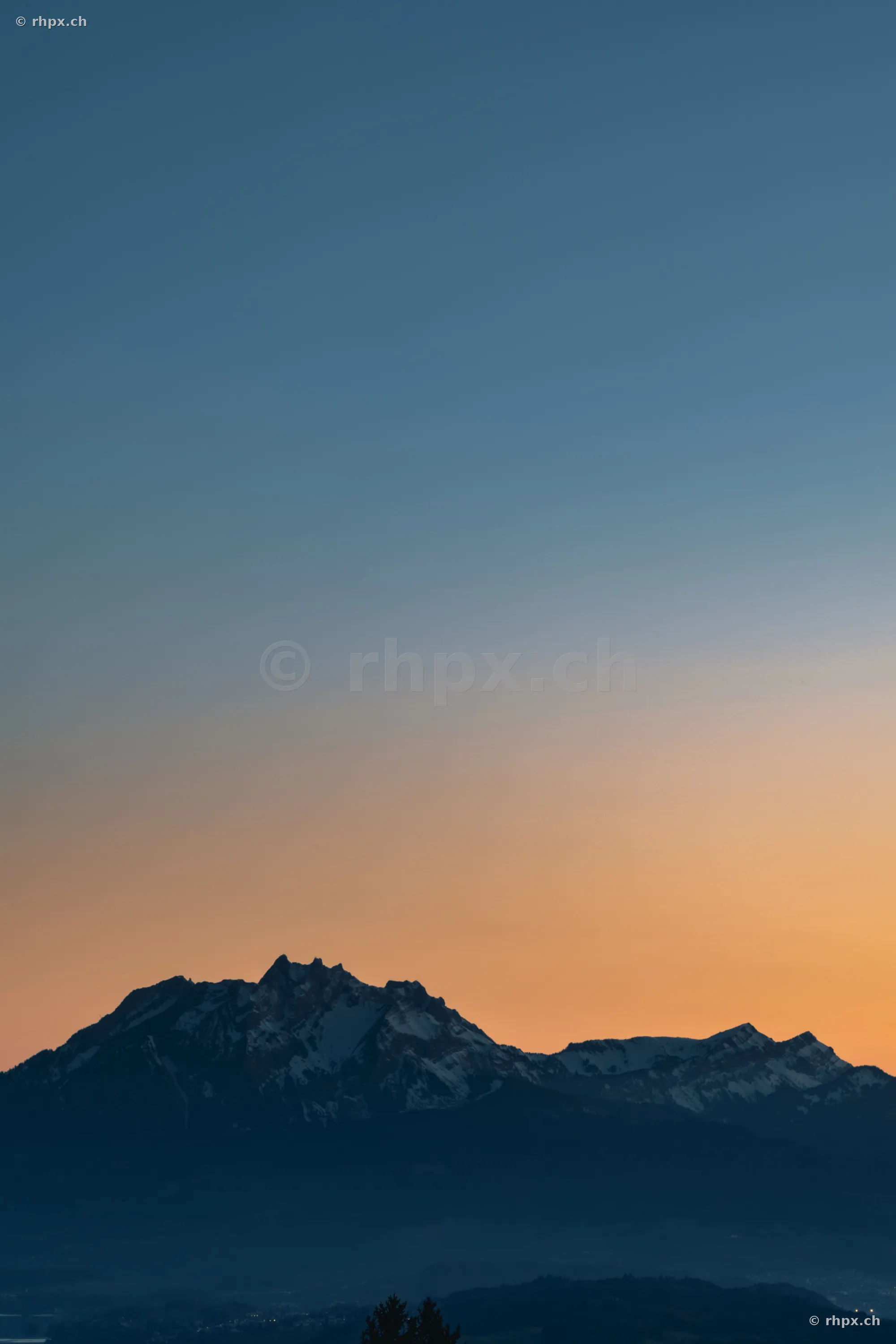 Mount Pilatus near Lucerne against an orange and blue evening sky