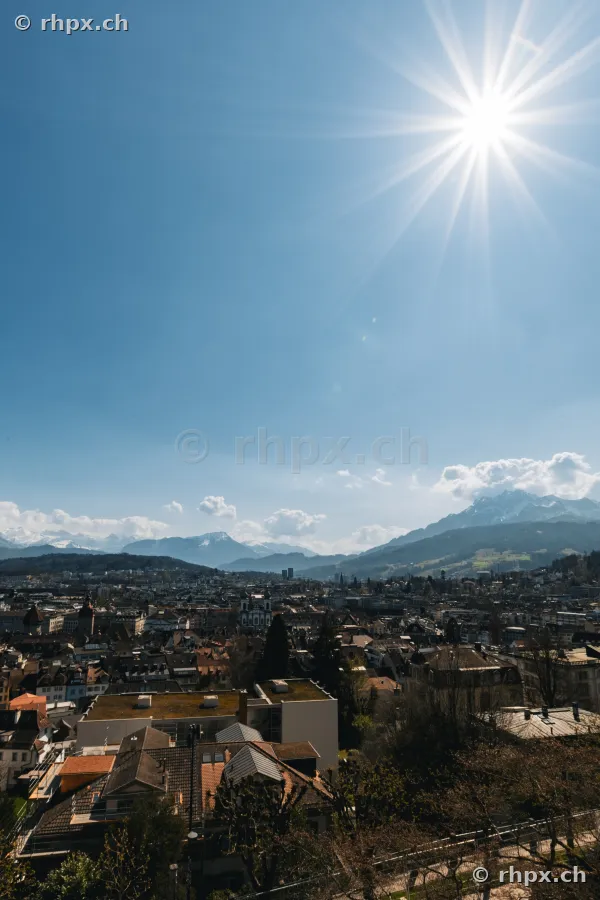 Aerial view of Lucerne city with Mount Pilatus in the background under blue sky