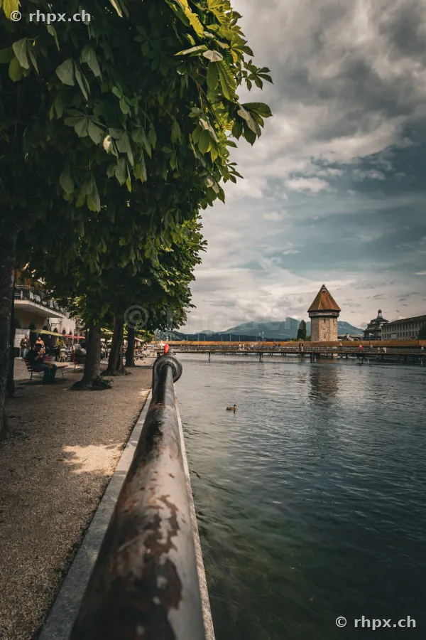 View along the Reuss riverbank with Chapel Bridge in the background, Lucerne