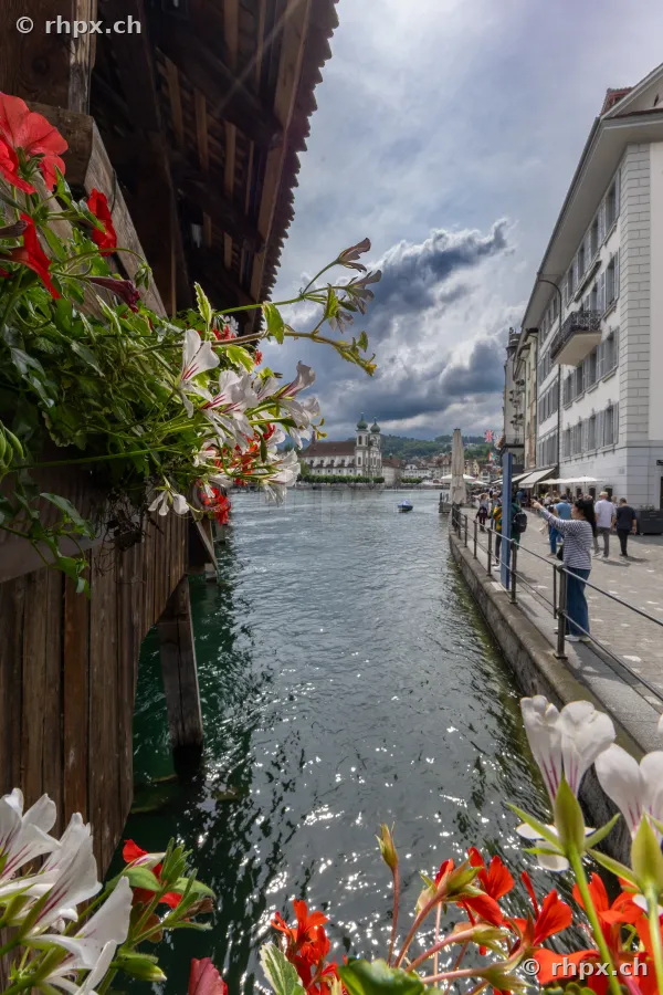 View from the Chapel Bridge over the Reuss river towards the Jesuit Church in Lucerne