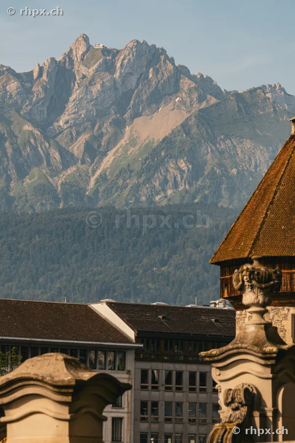 Stone decorations in the foreground and Pilatus massif in the background over Lucerne