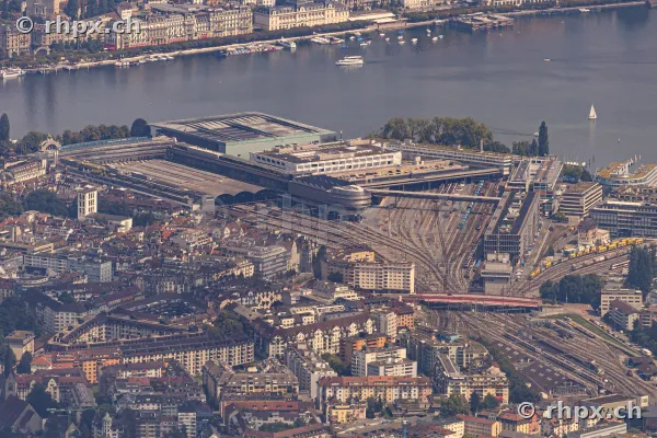 Aerial view of the Lucerne train station area with tracks and the adjacent Lake Lucerne