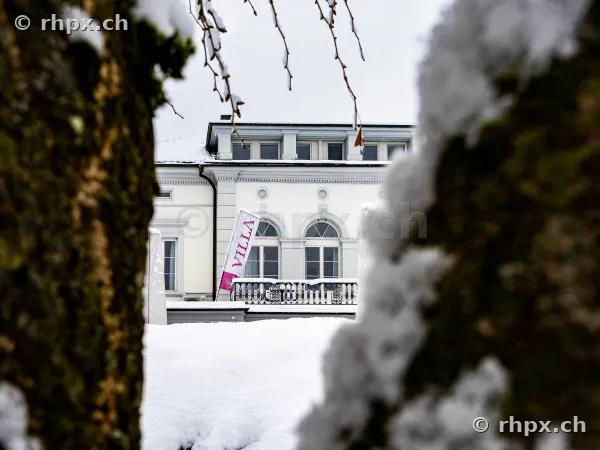 Villa Schweizerhof in Luzern durch schneebedeckte Bäume im Winter