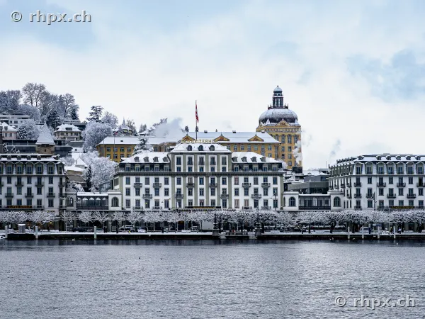 Front view of Hotel Schweizerhof Lucerne by the snow-covered lakeside