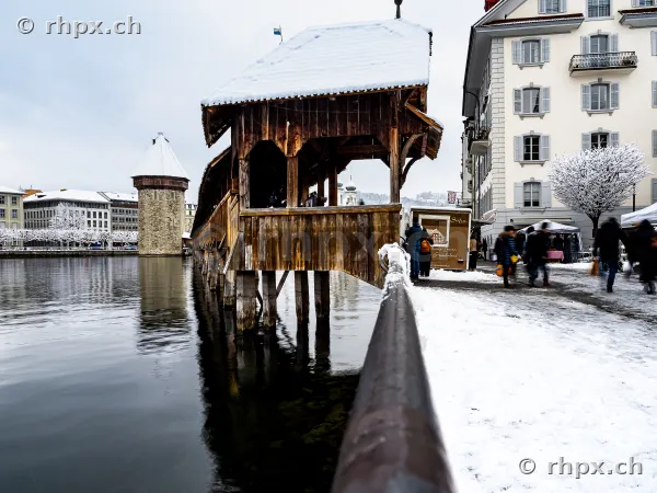 View of the snow-covered Chapel Bridge and the Water Tower in Lucerne in winter