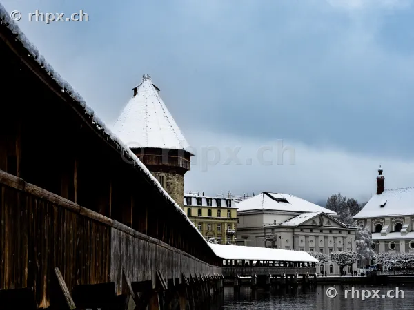 Chapel Bridge with Water Tower in Lucerne on a snowy winter day