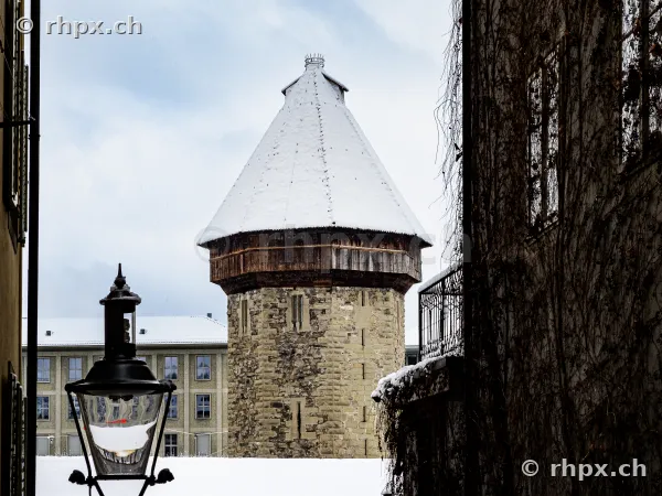 View through an alley towards the Water Tower in Lucerne in winter