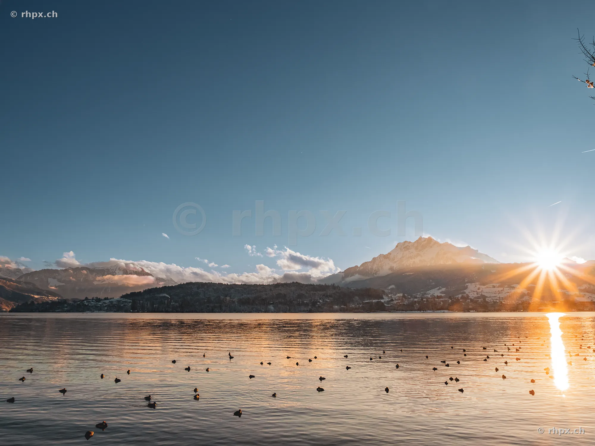 The snow-covered Mount Pilatus at sunrise over Lake Lucerne