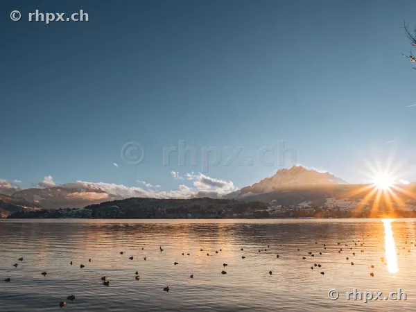 The snow-covered Mount Pilatus at sunrise over Lake Lucerne