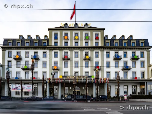 Frontalansicht des Hotels Schweizerhof Luzern mit bunten Balkonakzenten