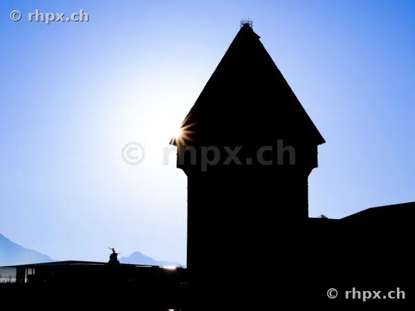 Silhouette of the Water Tower of the Chapel Bridge in Lucerne against a bright blue sky
