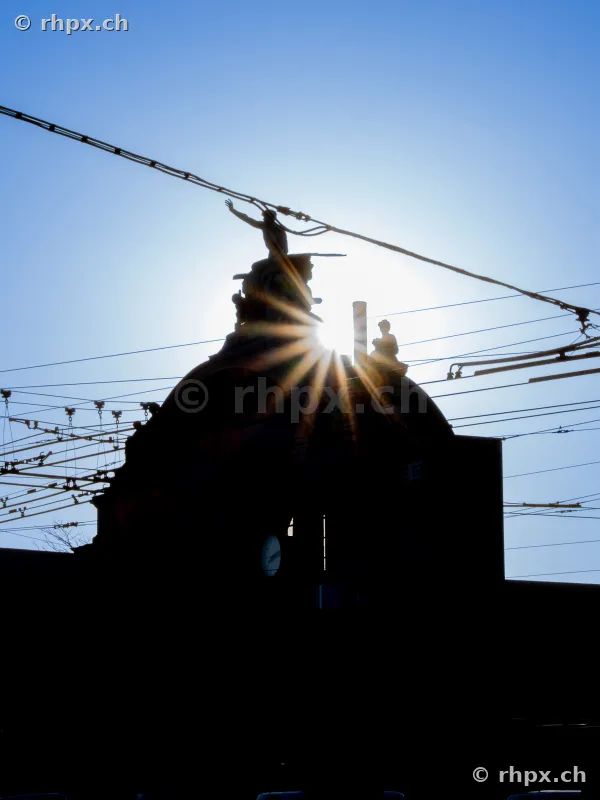 Silhouette of the sculpture on the dome of Lucerne station against the sun