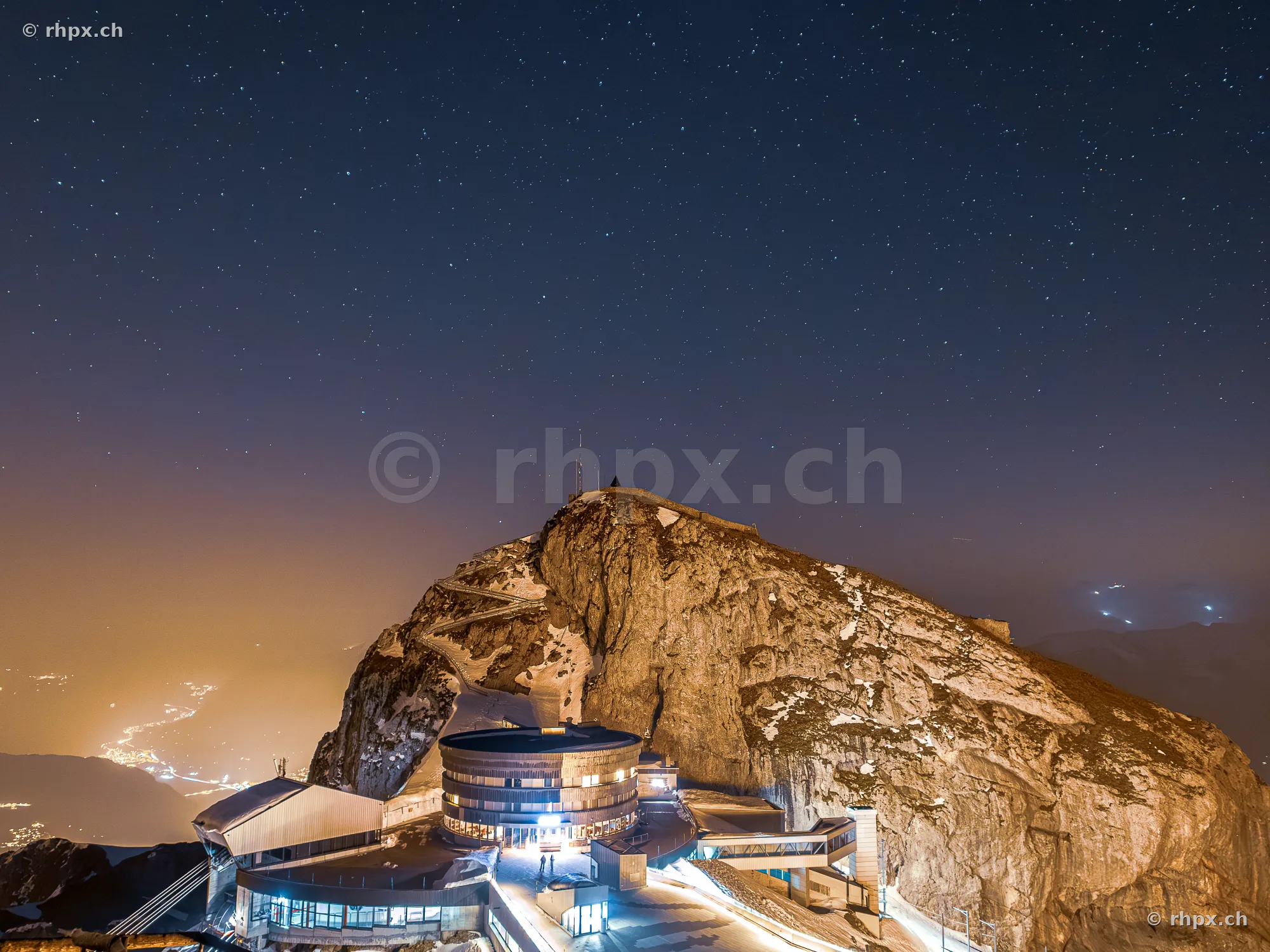 Night shot of Pilatus Kulm with starry sky and illuminated buildings
