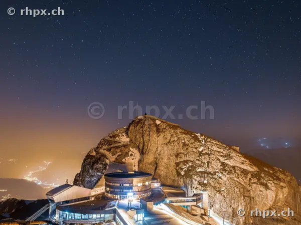Night shot of Pilatus Kulm with starry sky and illuminated buildings