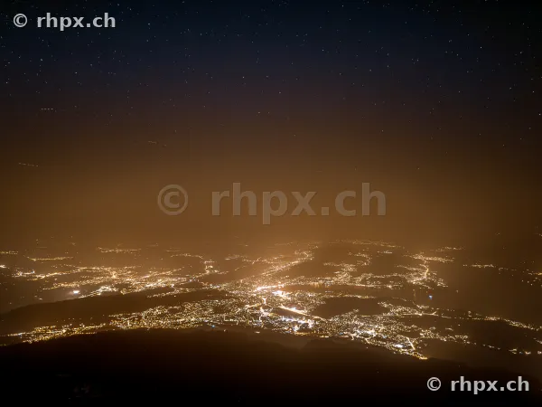 Night panoramic view from Mount Pilatus over the illuminated city and the starry sky