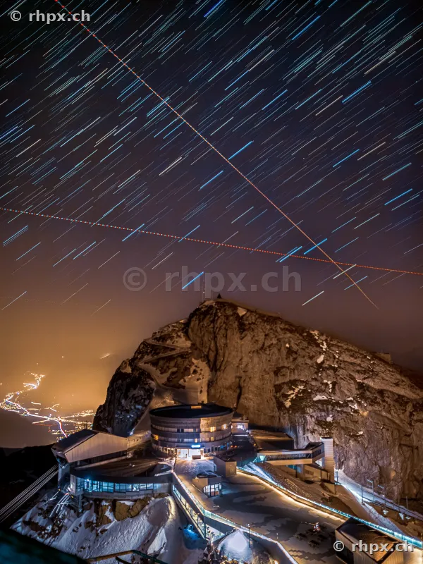 Long exposure of star trails over the night summit of Mount Pilatus with the Bellevue hotel