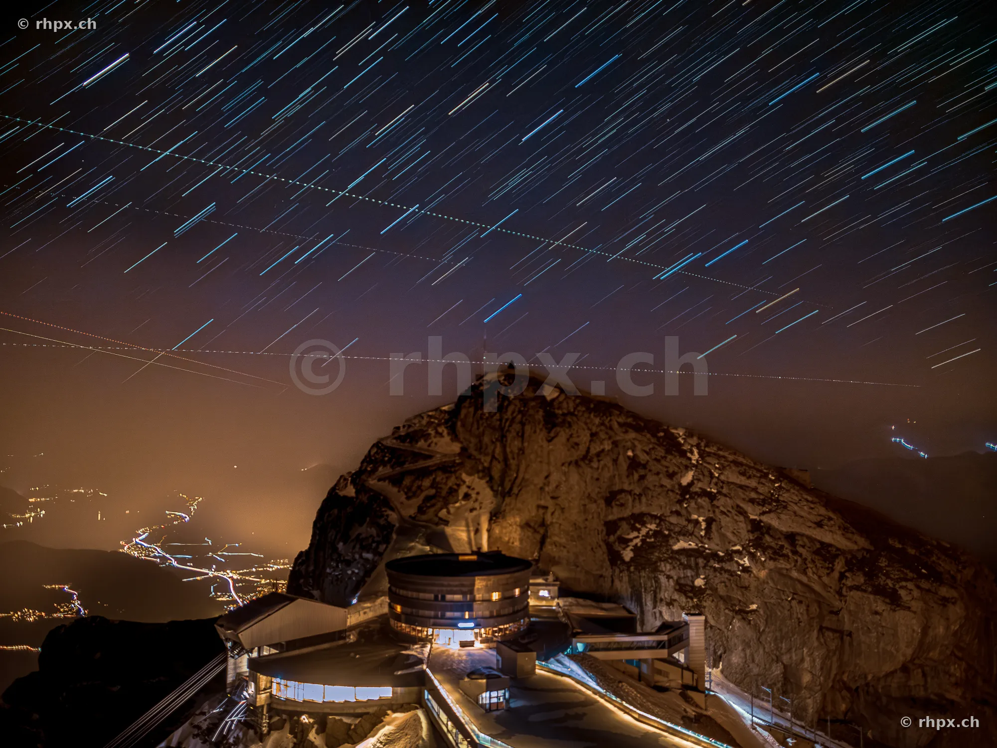 Star trails over the illuminated Pilatus Kulm at night