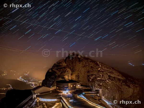 Star trails over the illuminated Pilatus Kulm at night