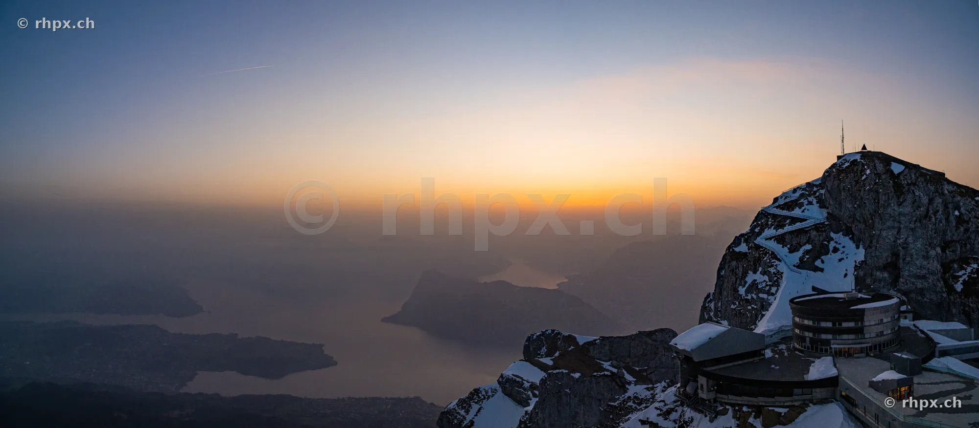 Snow-covered peak of Mount Pilatus in the sunset light overlooking Lake Lucerne