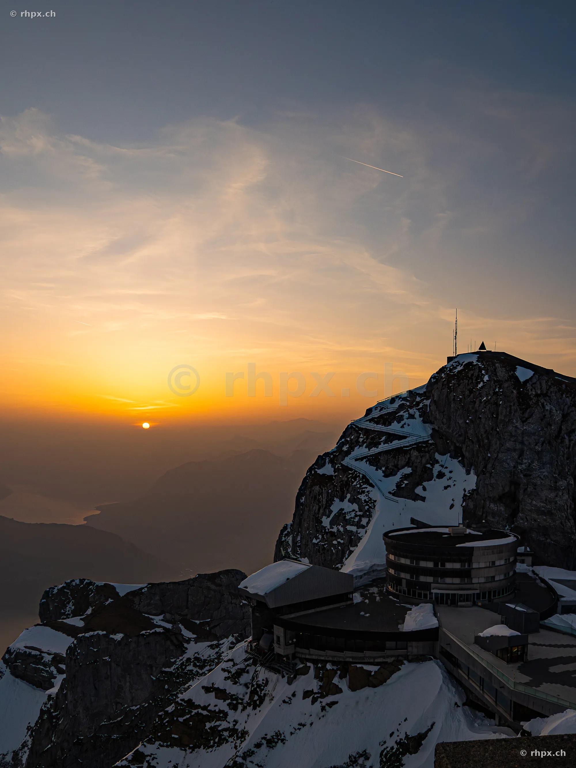 View of the Pilatus Kulm hotel and the mountain peak at sunset