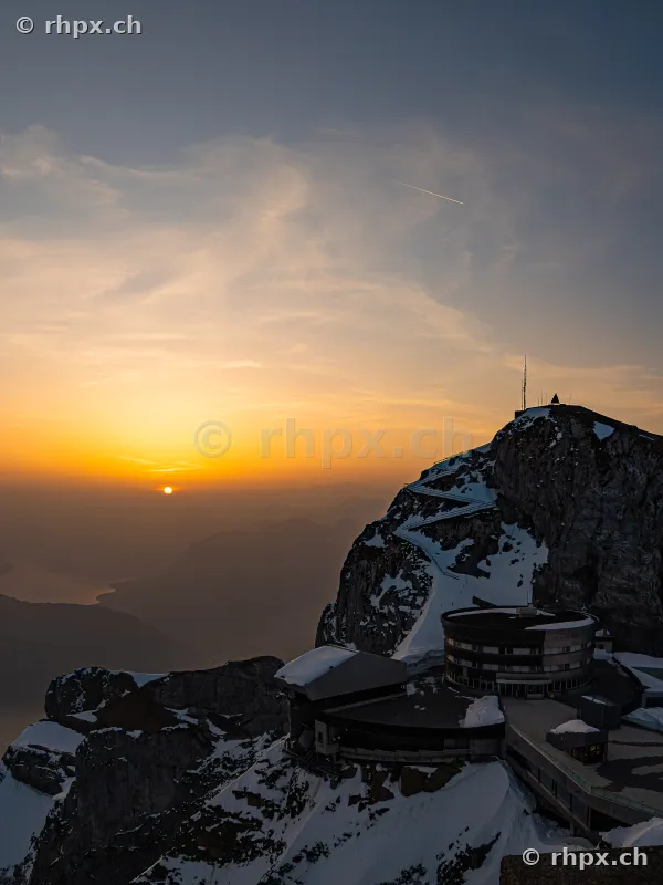 View of the Pilatus Kulm hotel and the mountain peak at sunset