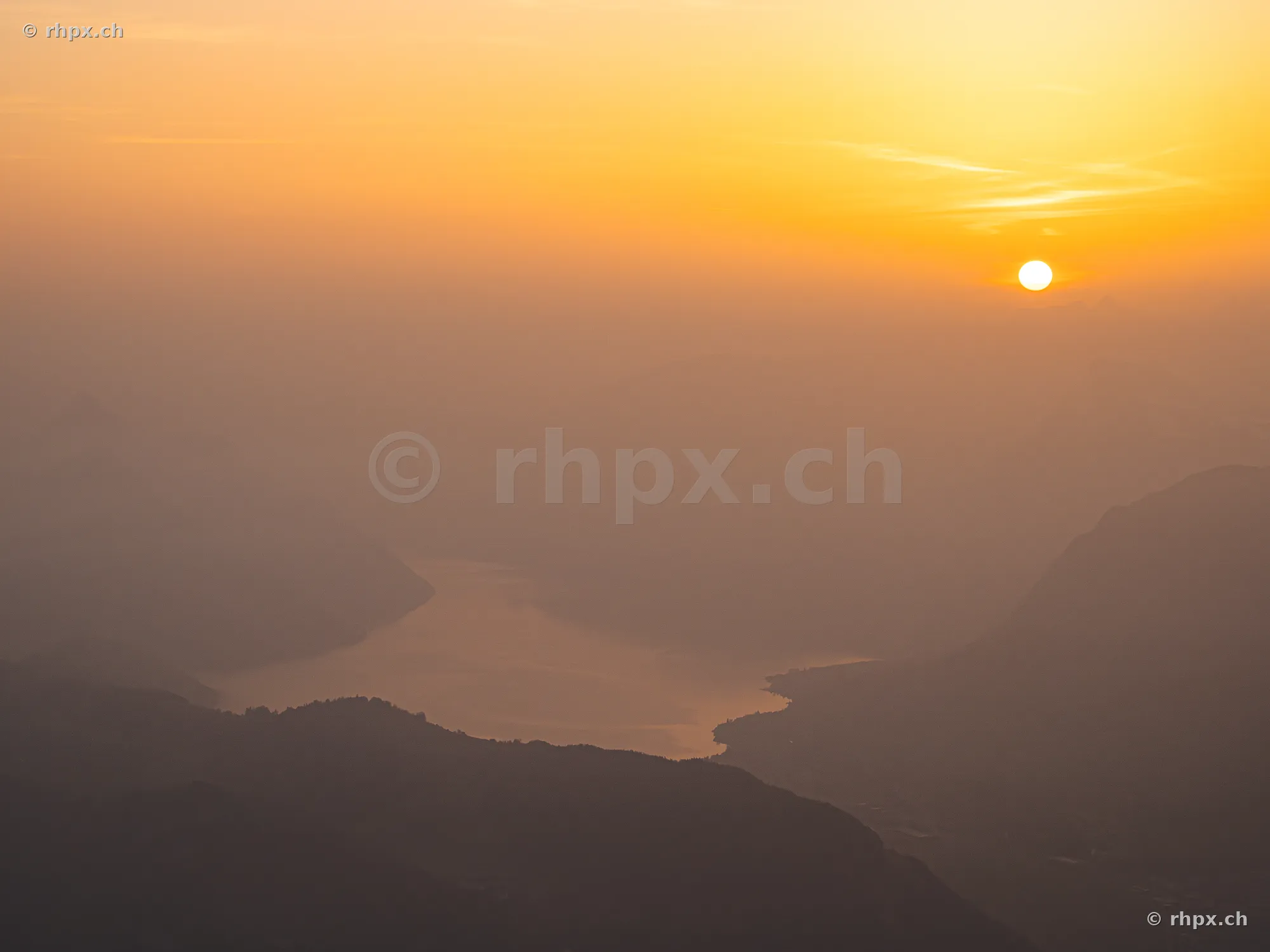 Blick vom Berg Pilatus über den in Dunst gehüllten Vierwaldstättersee im Morgenlicht.