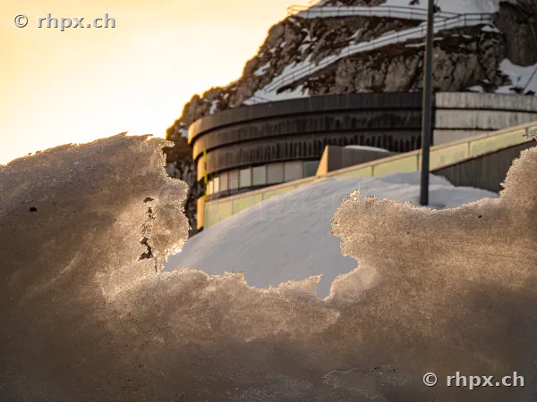 Winter landscape on Mount Pilatus with a view of the Pilatus-Kulm hotel through a snow formation