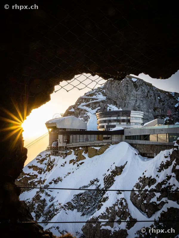 View from a rock tunnel looking towards the hotel and mountain station at Mount Pilatus in winter