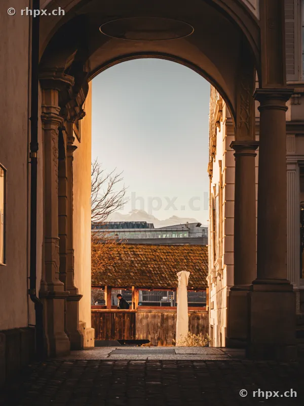 View through a stone archway towards the Chapel Bridge in Lucerne