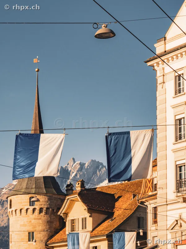 View of Lucerne old town with white and blue flags and Mount Pilatus in the background